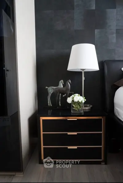 Elegant bedroom nightstand with modern lamp and decorative accents