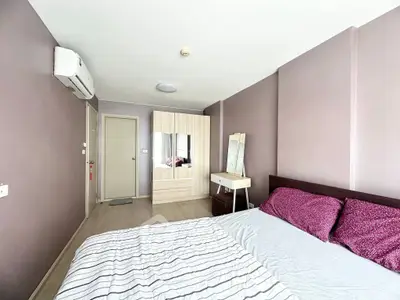 Spacious bedroom with modern decor and ample natural light