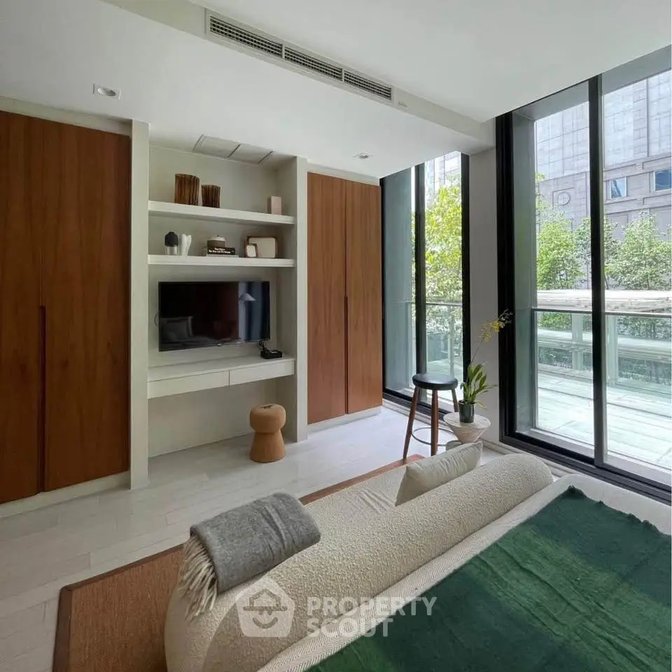 Modern living room with floor-to-ceiling windows and stylish decor