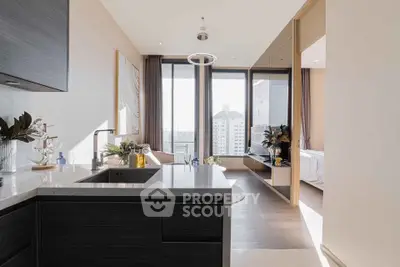 Luxurious modern apartment with open kitchen and stunning city view, featuring sleek design and ample natural light.