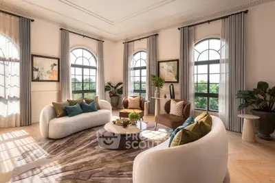 Luxurious living room with elegant furniture and large arched windows offering scenic views.