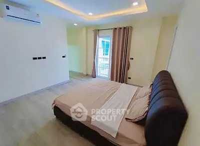 Spacious bedroom with modern design and balcony access