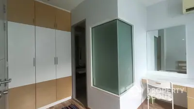 Modern bedroom with built-in wardrobe and vanity area