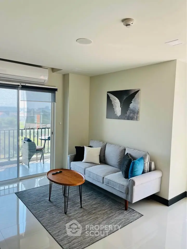 Modern living room with stylish decor and balcony view