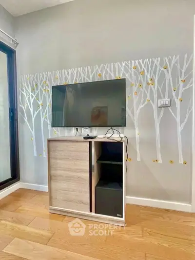 Modern living room with stylish TV stand and artistic wall design