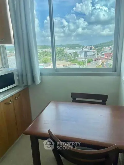 Cozy kitchen nook with scenic window view and wooden dining table