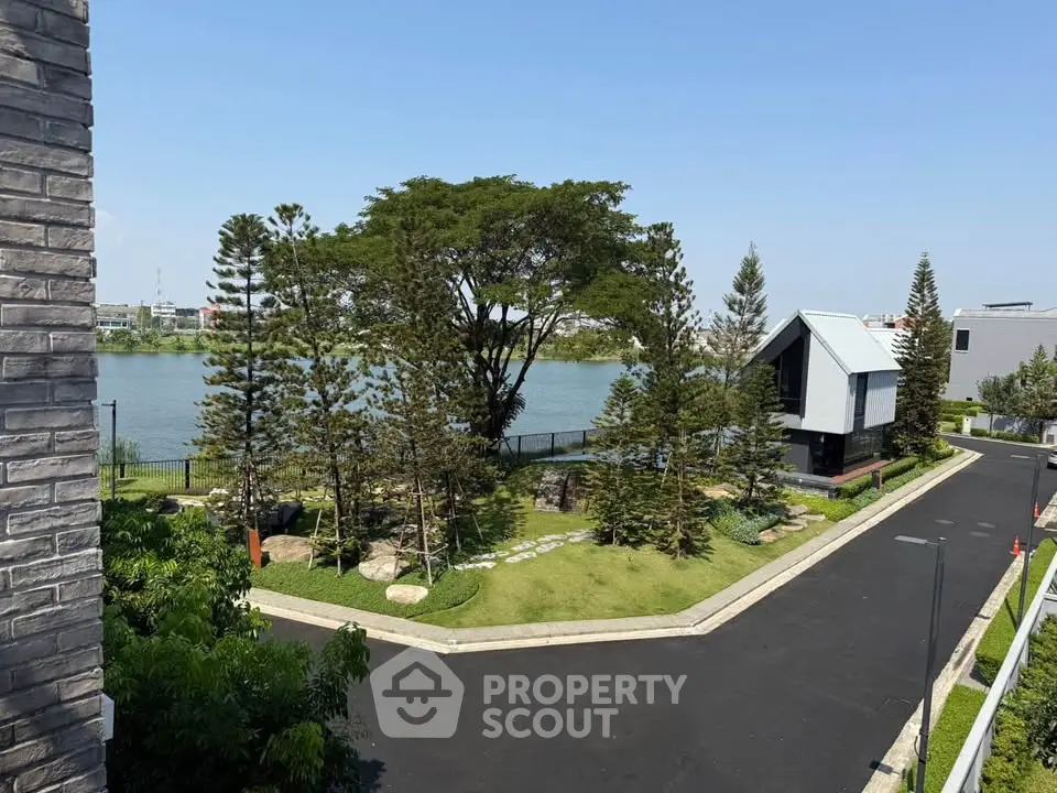Stunning lakeside property with lush garden and modern architecture, perfect for serene living.