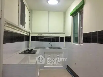 Compact kitchen with gas stove and sleek modern design