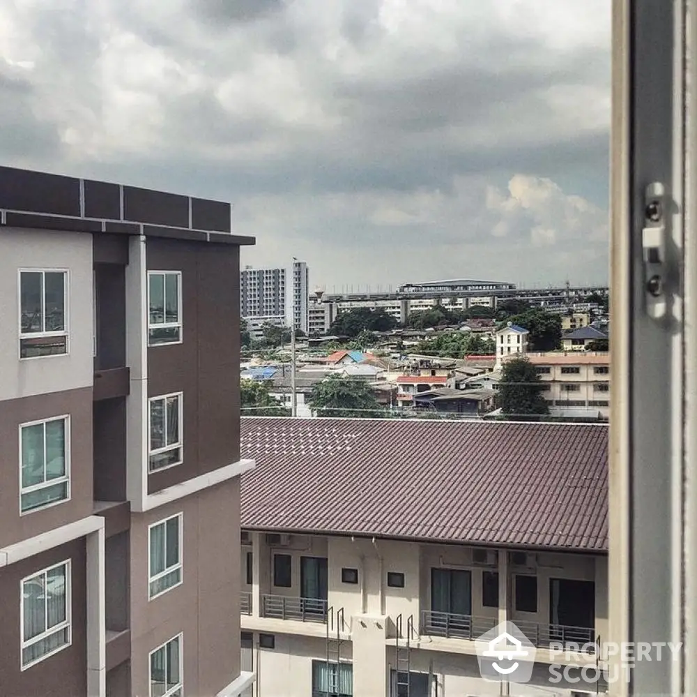 Urban apartment view with cityscape and cloudy sky