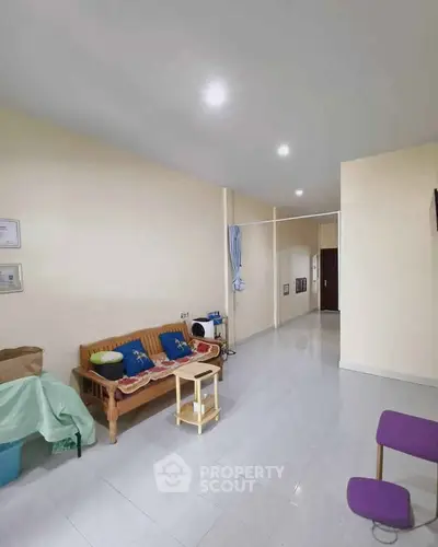 Spacious living room with minimalist decor and ample natural light