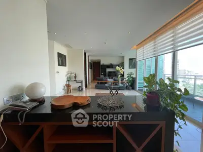 Spacious modern living room with balcony and city view