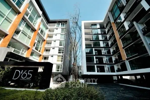 Modern condominium exterior with sleek design and lush greenery at D'65.