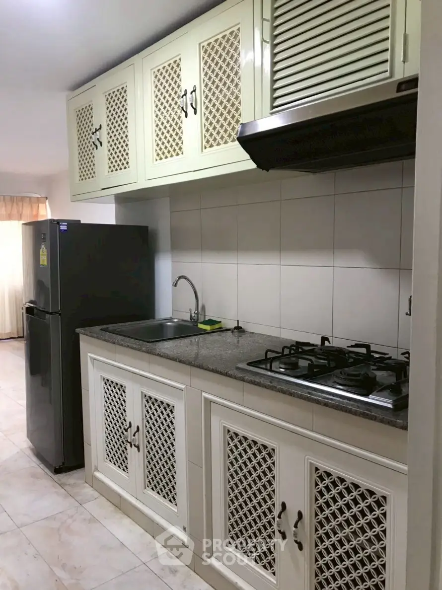 Charming kitchen with gas stove and ample storage in modern apartment