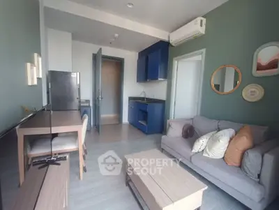 Modern living room with stylish decor and open kitchen layout in a cozy apartment.