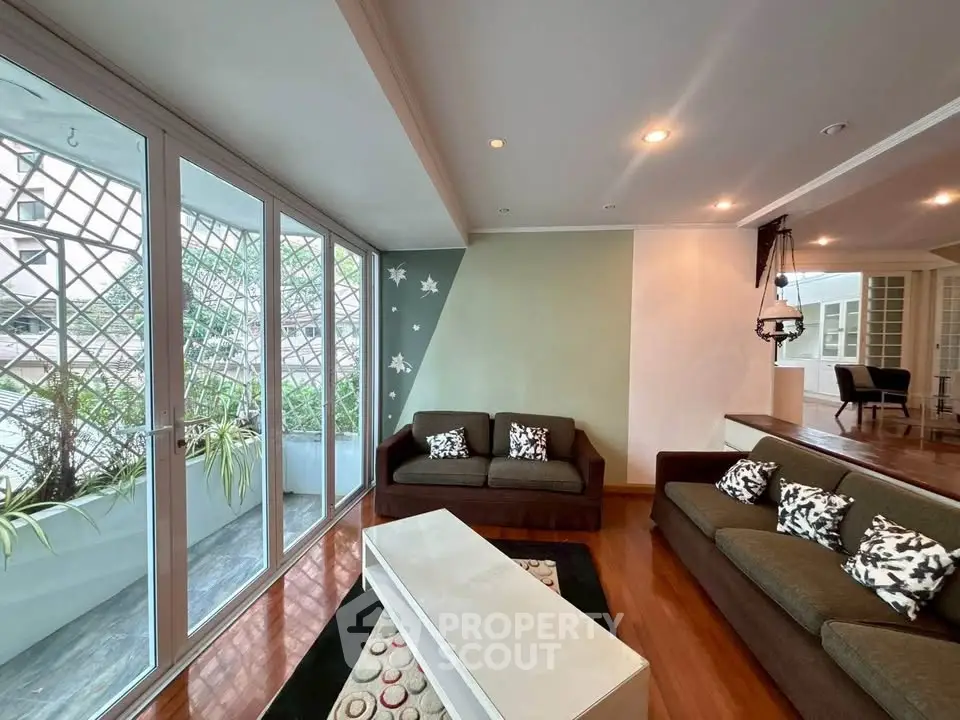 Spacious living room with large windows and stylish decor in modern apartment