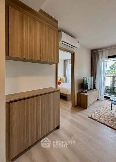 Modern apartment interior with wooden cabinets and cozy living area
