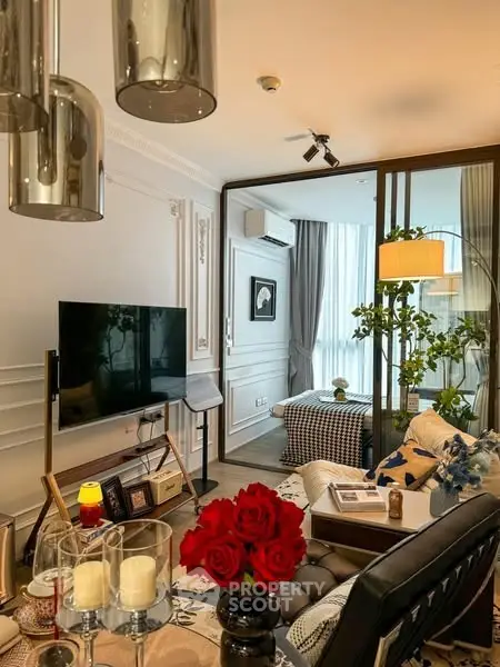 Luxurious living room with elegant decor and modern furnishings, featuring a large TV and stylish lighting.