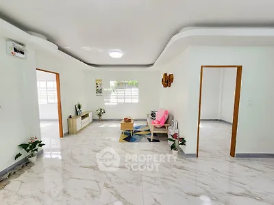 Spacious and bright living room with modern decor and marble flooring