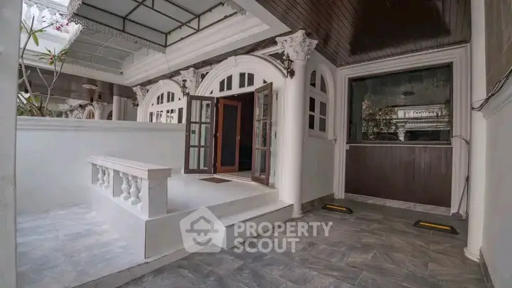 Elegant entrance with classic arches and modern flooring in a luxurious property.