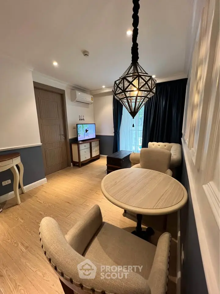 Charming living room with elegant lighting and cozy seating area, perfect for relaxation.