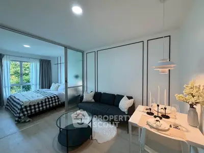 Modern open-plan living room with cozy bedroom and stylish decor