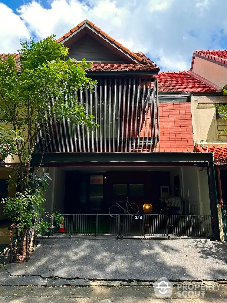 Charming townhouse with red tile roof and modern facade in a serene neighborhood.