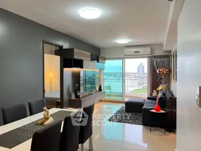 Modern living room with stylish decor and balcony view in a high-rise apartment.