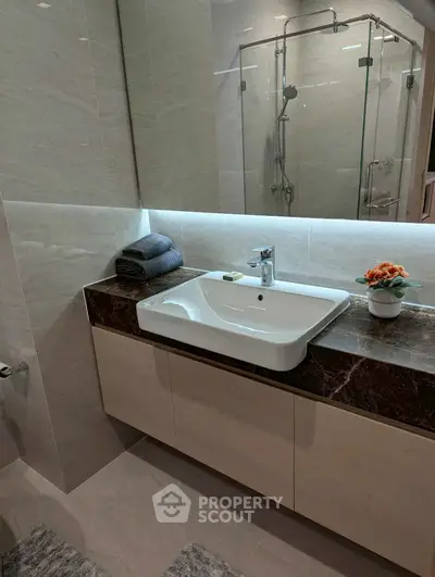 Modern bathroom with sleek sink and glass shower enclosure