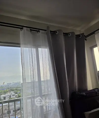 Spacious apartment with large windows offering a stunning city view, perfect for natural light lovers.