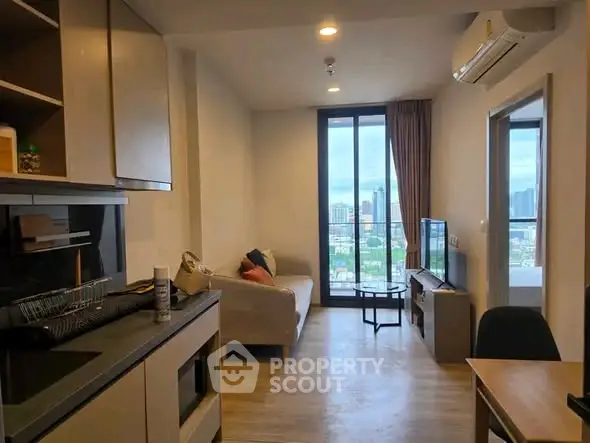 Modern living room with city view, open layout, and stylish furnishings in a high-rise apartment.