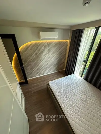 Modern bedroom with stylish lighting and large window view