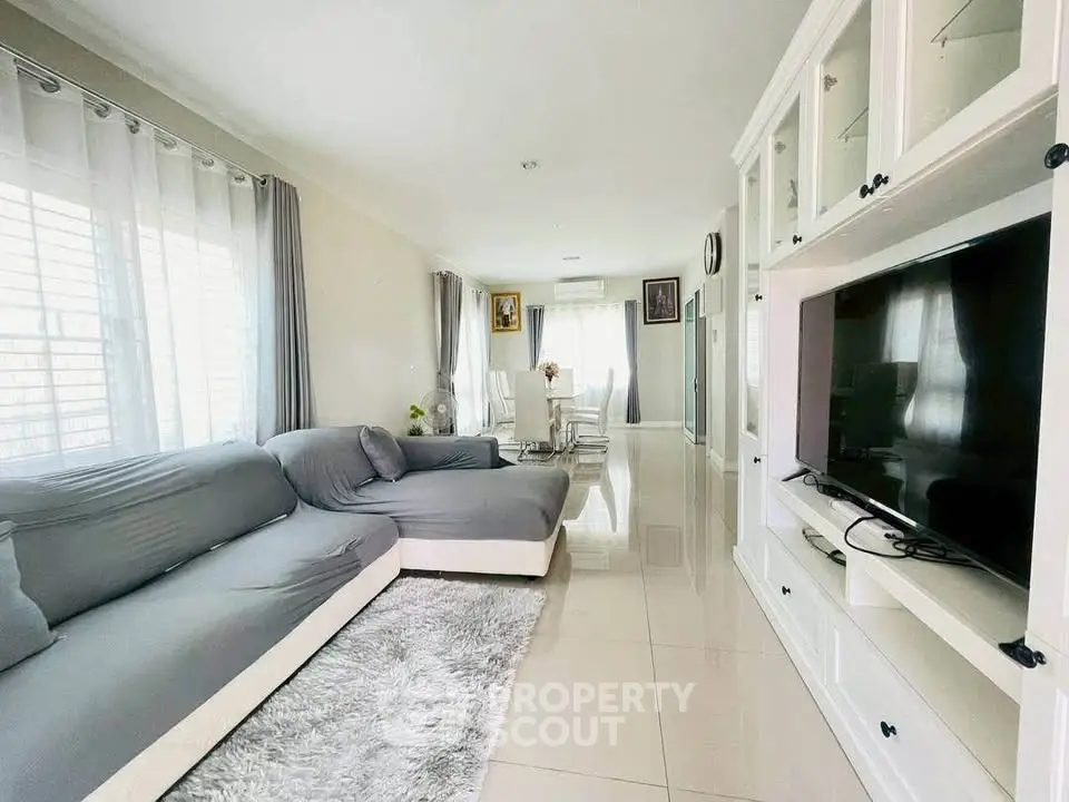 Spacious living room with modern decor and large windows for natural light.