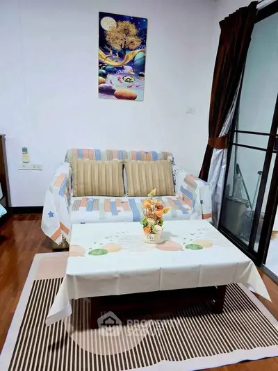 Cozy living room with stylish decor and balcony access, perfect for relaxation and entertaining.