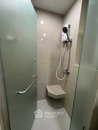 Modern bathroom with glass shower and sleek tile design