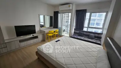 Modern bedroom with stylish furniture and large windows in a contemporary apartment.
