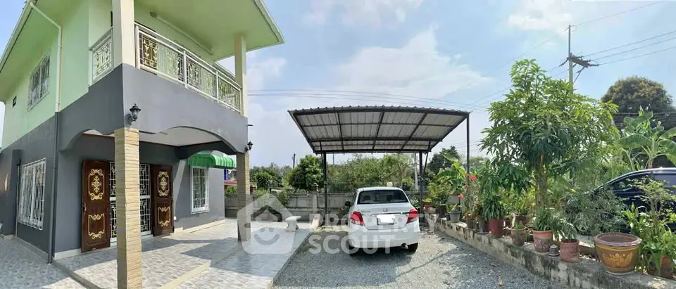 Charming two-story home with carport and lush garden, perfect for family living.