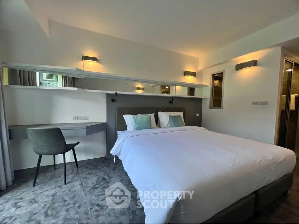 Modern bedroom with stylish decor and cozy ambiance, featuring a comfortable bed and sleek furnishings.