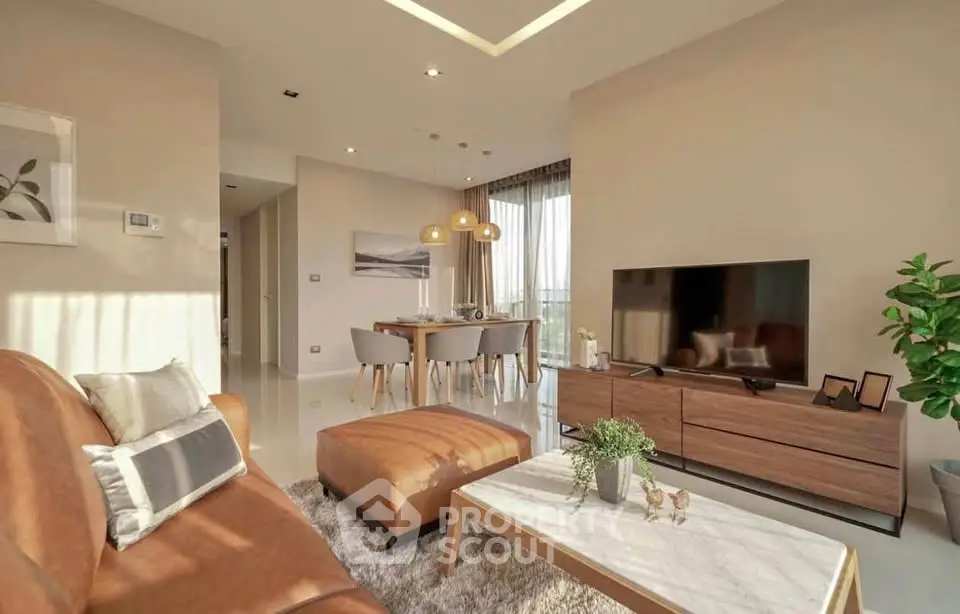 Modern living room with stylish decor and natural light, featuring a cozy seating area and dining space.