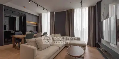 Luxurious modern living room with elegant dining area and floor-to-ceiling windows.