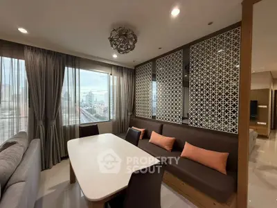 Modern living room with city view, stylish decor, and ample natural light.