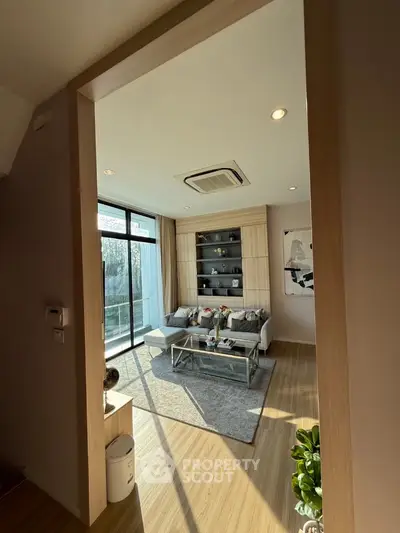 Modern living room with large windows and stylish decor
