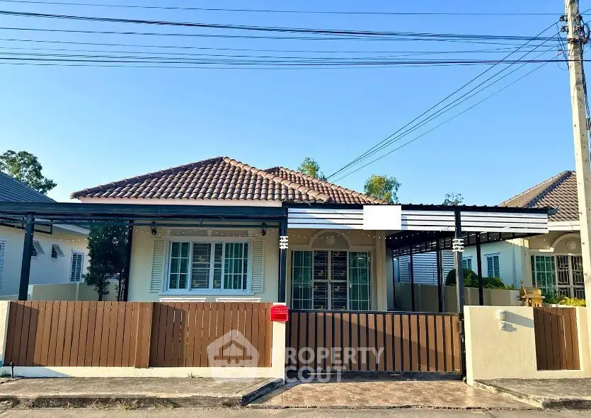 Charming single-story home with tiled roof and fenced yard in a serene neighborhood.