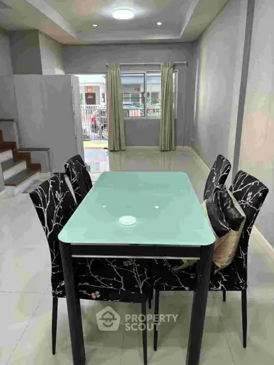 Spacious dining area with modern table and chairs, perfect for family gatherings.