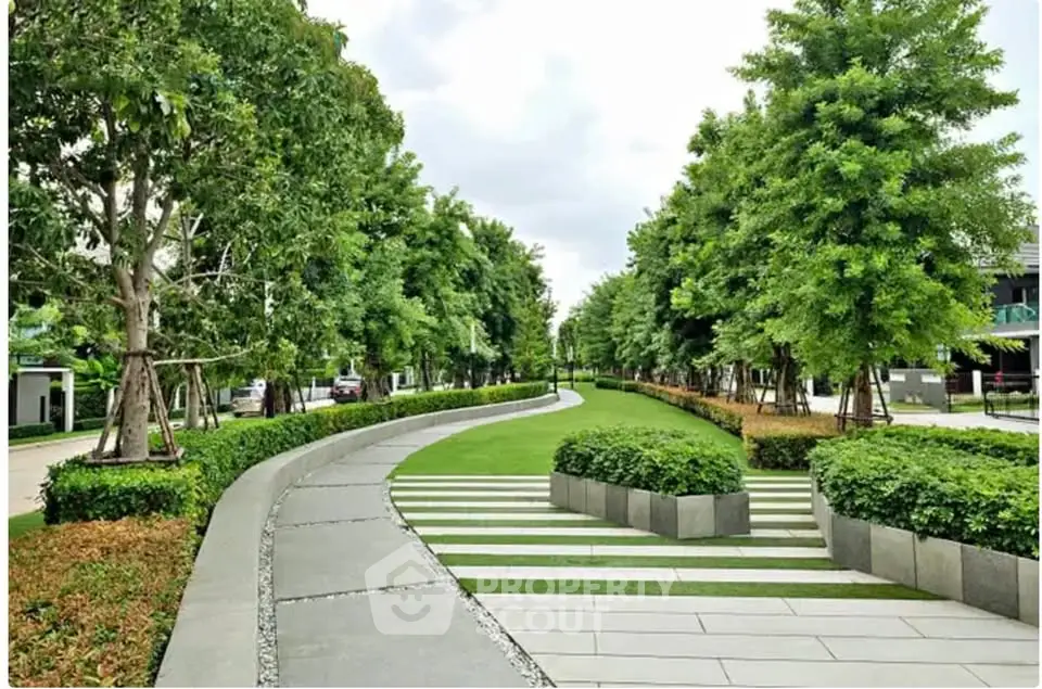Lush green garden pathway in modern residential complex