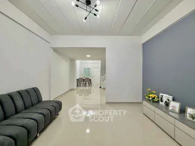 Spacious modern living room with sleek furniture and elegant lighting