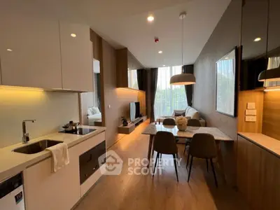 Modern open-plan kitchen and living area with stylish decor and natural light.