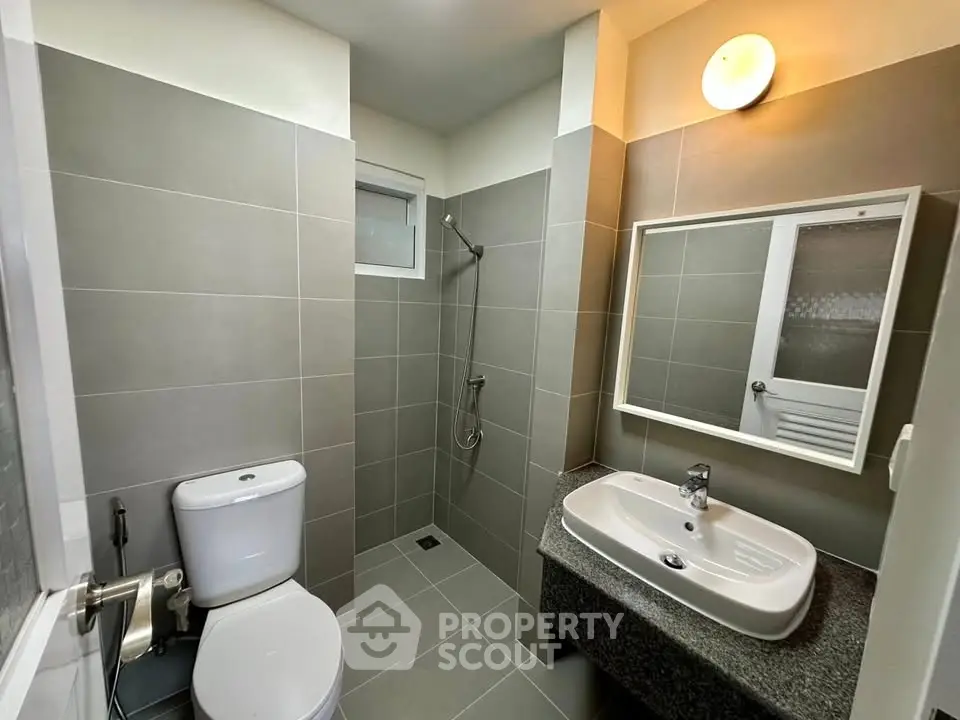 Modern bathroom with sleek gray tiles and contemporary fixtures