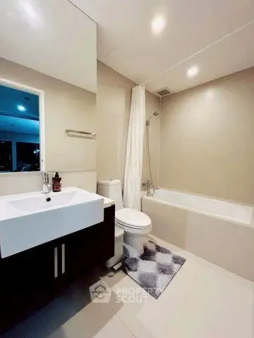 Modern bathroom with bathtub and sleek fixtures in a contemporary apartment.