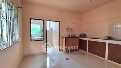 Spacious kitchen with ample storage and natural light, perfect for culinary enthusiasts.
