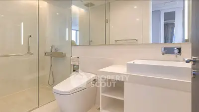 Luxurious modern bathroom with sleek fixtures and spacious shower area.